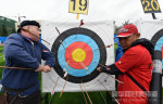 Staff clear a target at the 1st 'Li Guang Cup' International Archery Tournament, in Gansu.
